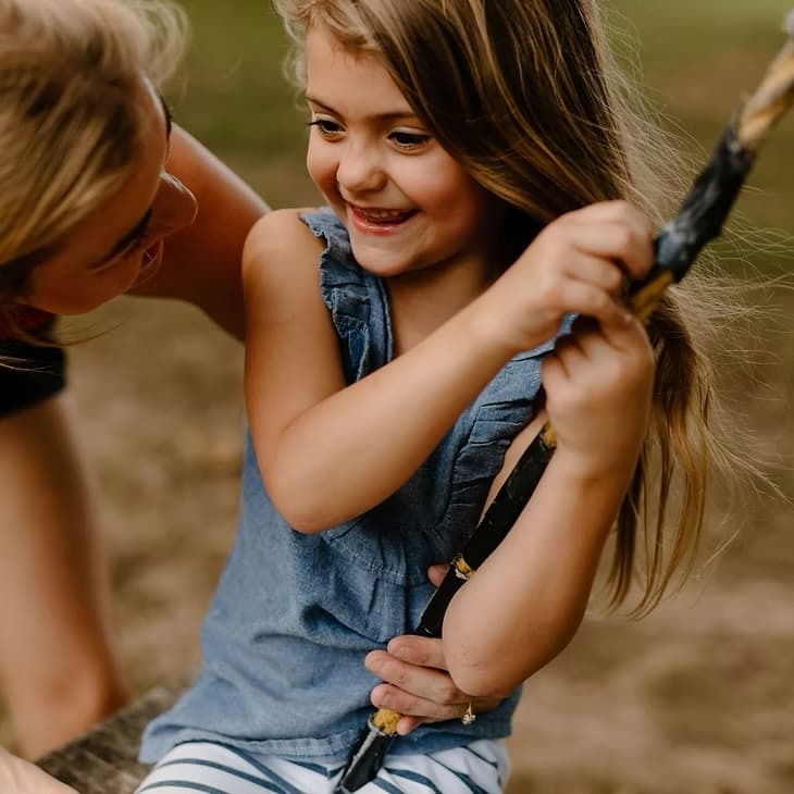 A Child Therapy Center clinician connecting with a child outdoors